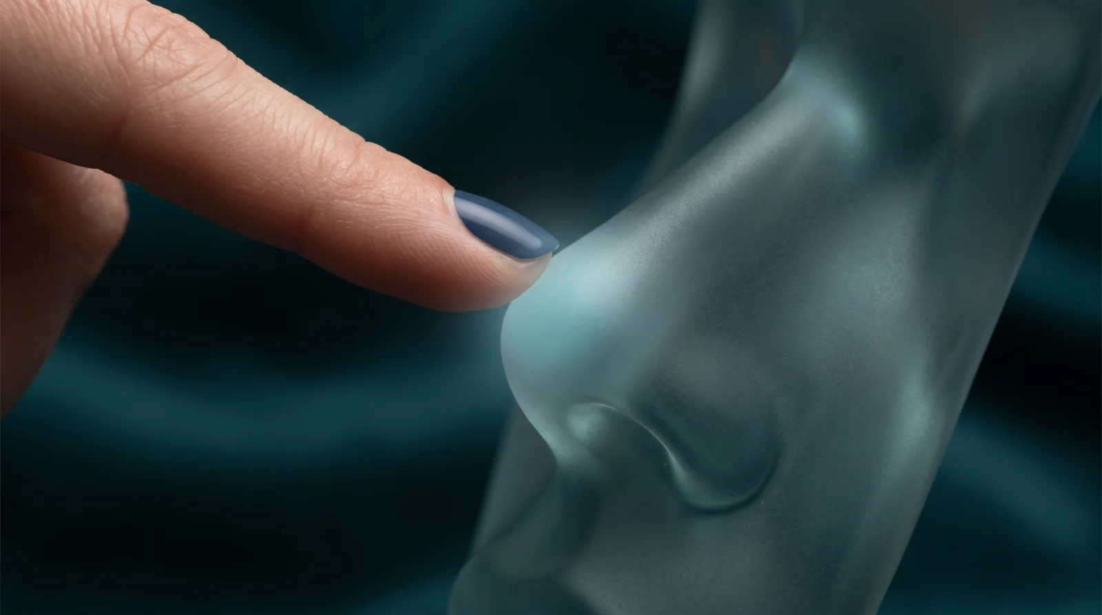 Frosted glass sculpture of a nose tip with faint nerve-like lines, suggesting sensation and numbness after rhinoplasty